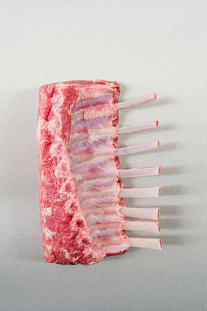 Raw rack of lamb on stainless steelの写真素材