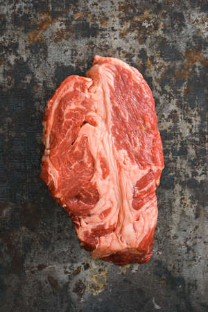 Chuck eye steak on dark rustic backgroundの写真素材