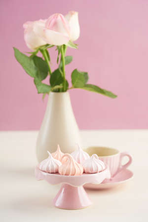 Tea time with meringue kisses confectionary and rosesの写真素材