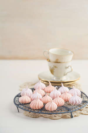 Tea time with pastels colored meringue kisses confectionaryの写真素材