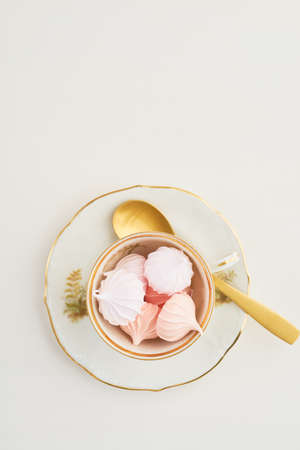 Tea time with pastels colored meringue kisses confectionaryの写真素材