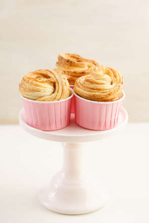 Fresh baked cruffins trend pastry on pink cake stand