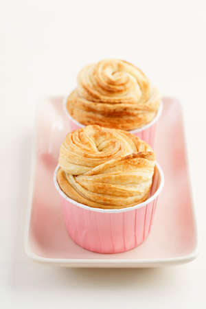 Fresh baked cruffins trend pastry on pastel tablewareの写真素材