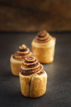Fresh baked cruffins trend pastry on rustic dark backgroundの写真素材