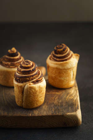 Fresh baked cruffins trend pastry on rustic wooden boardの写真素材