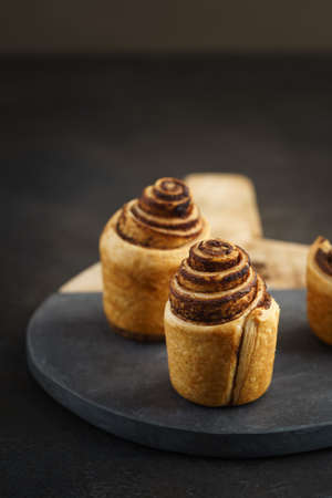 Fresh baked cruffins trend pastry on rustic wooden boardの写真素材