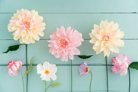 Crepe paper flowers dahlias, cosmos and echinacea on turquoise wooden backgroundの写真素材