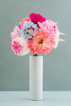 Crepe paper flower bouquet with peonies, hyacinth, garden rose and poppies in a vaseの写真素材