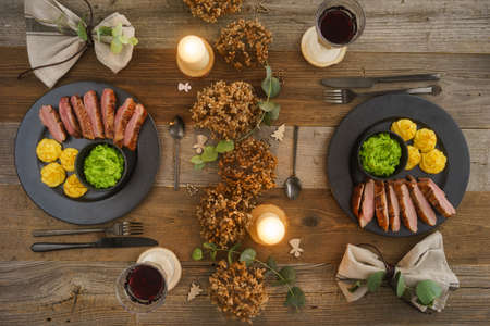 Christmas menu with duck breast, mushy peas, duchess potatoes and wineの写真素材