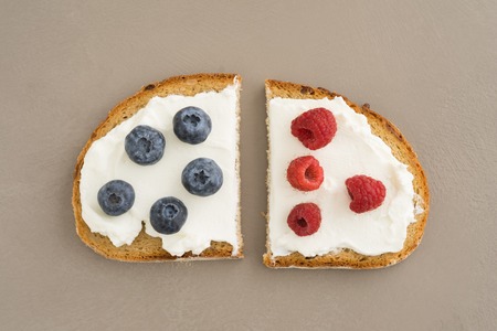 Sandwich cut in half with cream cheese and fresh fruitの写真素材