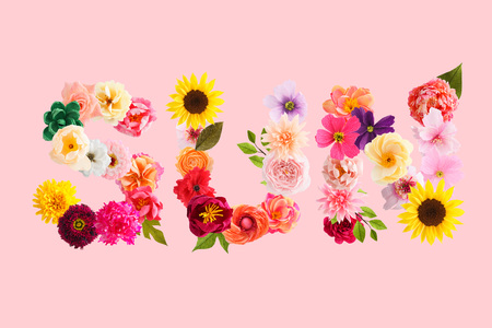 Word sun made of crepe paper flowers isolated on pink backgroundの写真素材