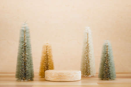 Wooden podium pedestal product mockup display with miniature Christmas trees in beige and green, 3d illustrationの写真素材