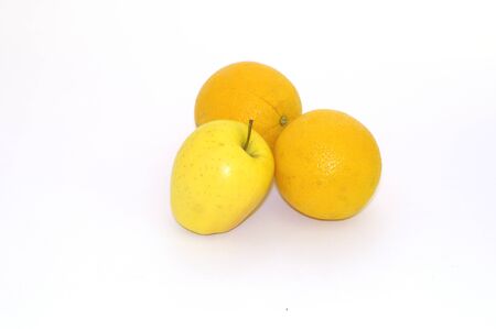 Two oranges and one apple on white backgroundの写真素材