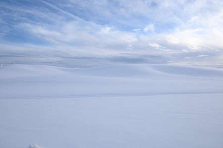 Snow Covers the Countryside Under a Partly Cloudy Sky on a Cold Winter Day on the Palouse of Washington State.の写真素材