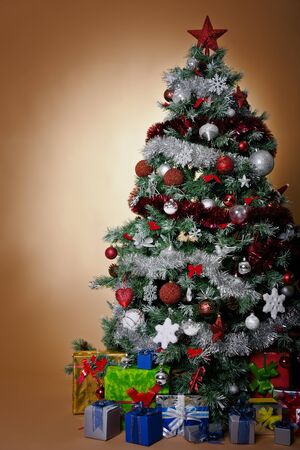 isolated chirstmas tree with silver and red decorationの写真素材