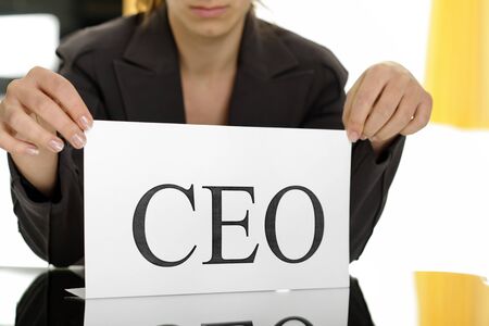 business woman showing paper with CEO written on it