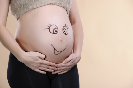 beautiful and curly pregnant woman studio shootの写真素材