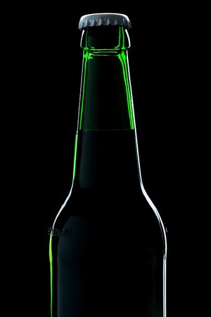 beer bottle close-up over black backgroundの写真素材