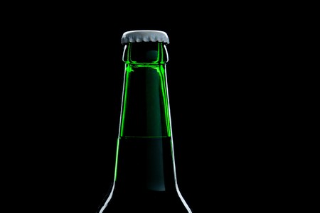 green bottle beer close-up over black backgroundの写真素材
