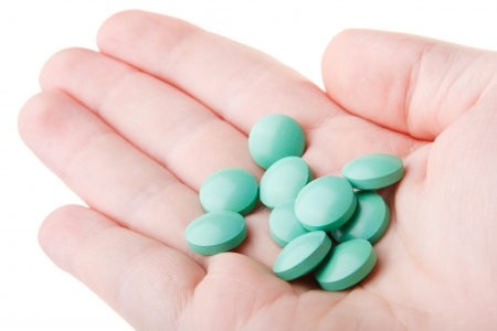 Hands with pills isolated on white backgroundの写真素材