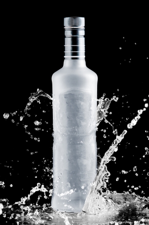 iced bottle of vodka splash on a black backgroundの写真素材