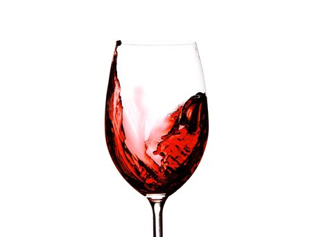 red wine splashing in a glass, isolated on whiteの写真素材