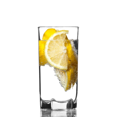 Full glass of water with lemon isolated on white backgroundの写真素材