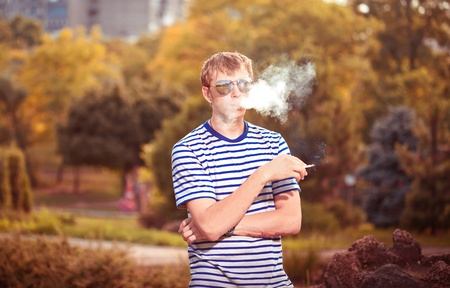 Man smoking a cigarette outsideの写真素材