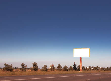 Road in a village with an empty billboardの写真素材