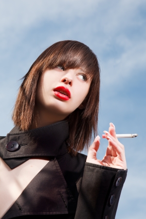young elegant girl with a cigaretteの写真素材