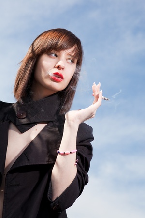 young elegant girl with a cigaretteの写真素材