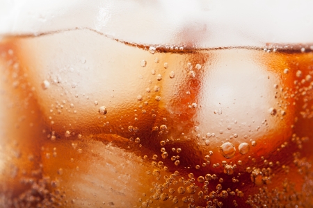 cola with ice cubes close up