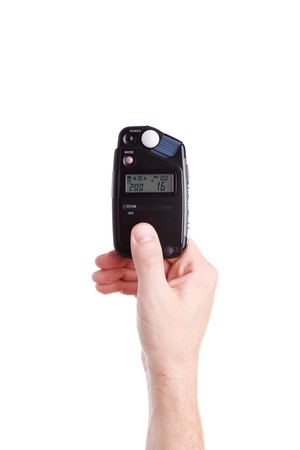 flash meter in hand on white backgroundの写真素材