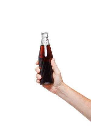 hand holding a bottle of cola on white backgroundの写真素材