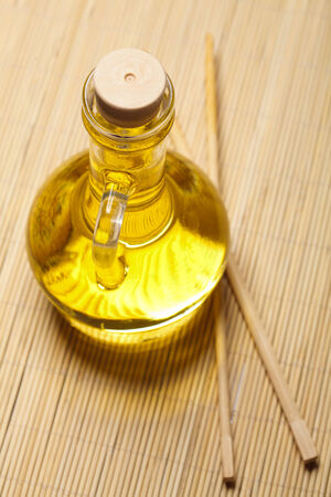 Olive oil and sticks on the wooden backgroundの写真素材