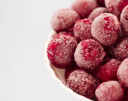 frozen cherries in the plate on white background