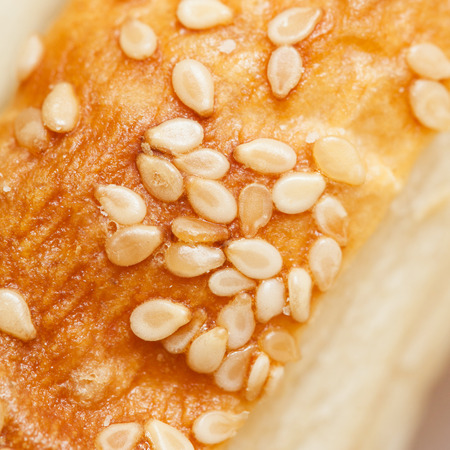 bun with sesame seeds for a hamburger isolated on white background, close-up.の写真素材