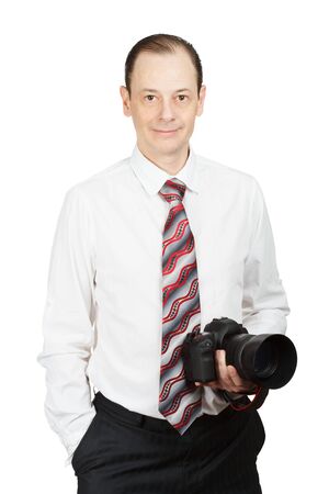 young handsome man in white shirt with a tie and a photo camera in hand isolated on white backgroundの写真素材