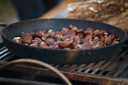 roasted chestnuts in a pan on the natureの写真素材