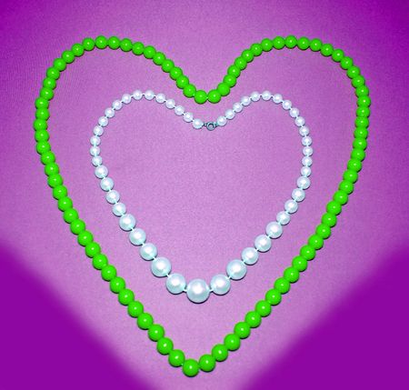 The Necklace on violet background.Two necklaces of the miscellaneous of the colour. The Still life.の写真素材