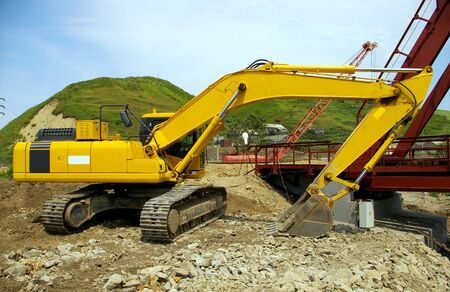 The Big caterpillar excavator of the yellow colour after functioning.