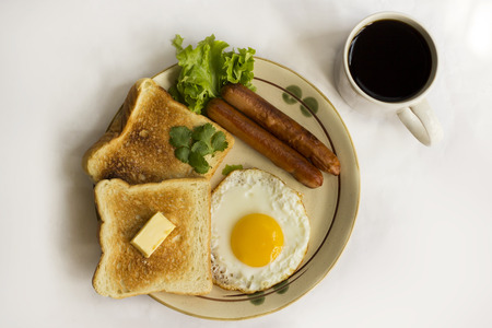 healthy breakfast fried egg yellow yolk, toast bread, sausage, vegetable in morning,  delicious...