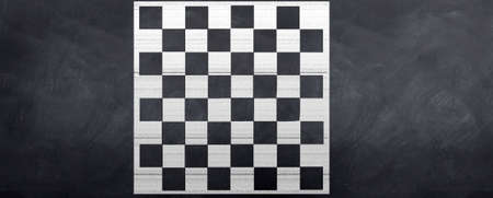 A chalk chessboard is drawn on the blackboard. Ready for the game to beginの写真素材