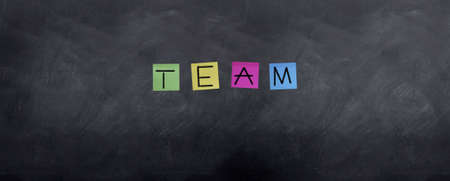 Team is spellt in post it notes stuck to the board.の写真素材
