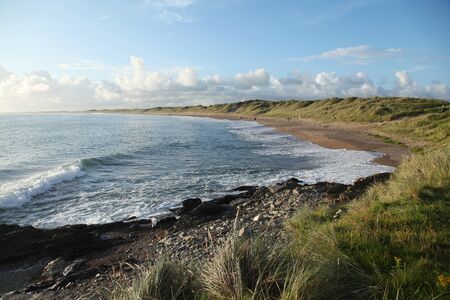 Waves on the beach in the evening in Kilmore Quay in Irelandの写真素材