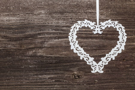Metal heart on wooden boardの写真素材