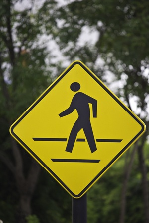 walking sign in the yellow backgroundの写真素材