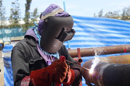 local metal worker is welding steel structure for new house terrace, Thailand