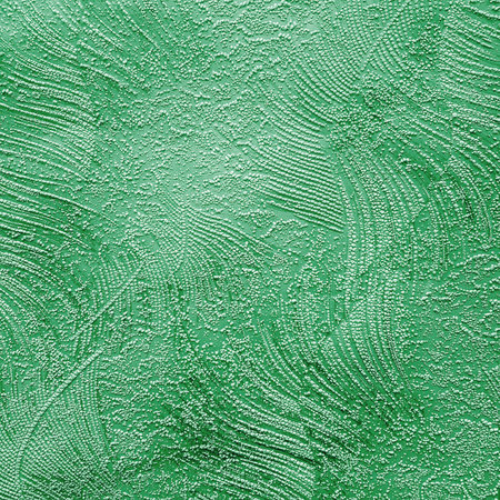 Green ceramic tile with floral pattern for wall and floor decor. Concrete stone surface background. Texture with ornament for interior design project.の写真素材