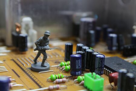 Toy weapons on a board represent cyber warの写真素材